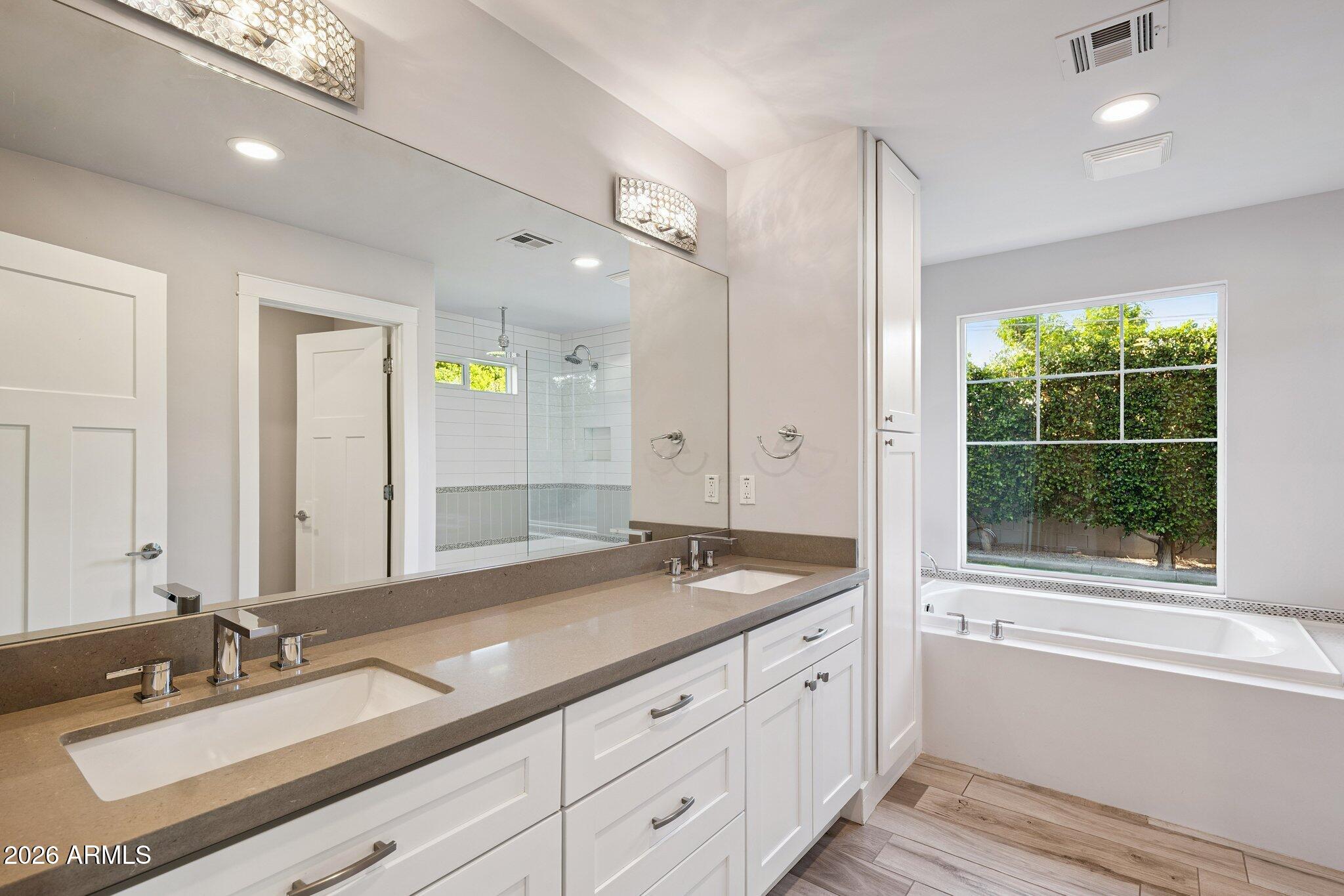 4232 North 19th Place Phoenix, AZ 85016 - Photo 21 of 39 a spacious bathroom with a granite countertop sink and a large mirror