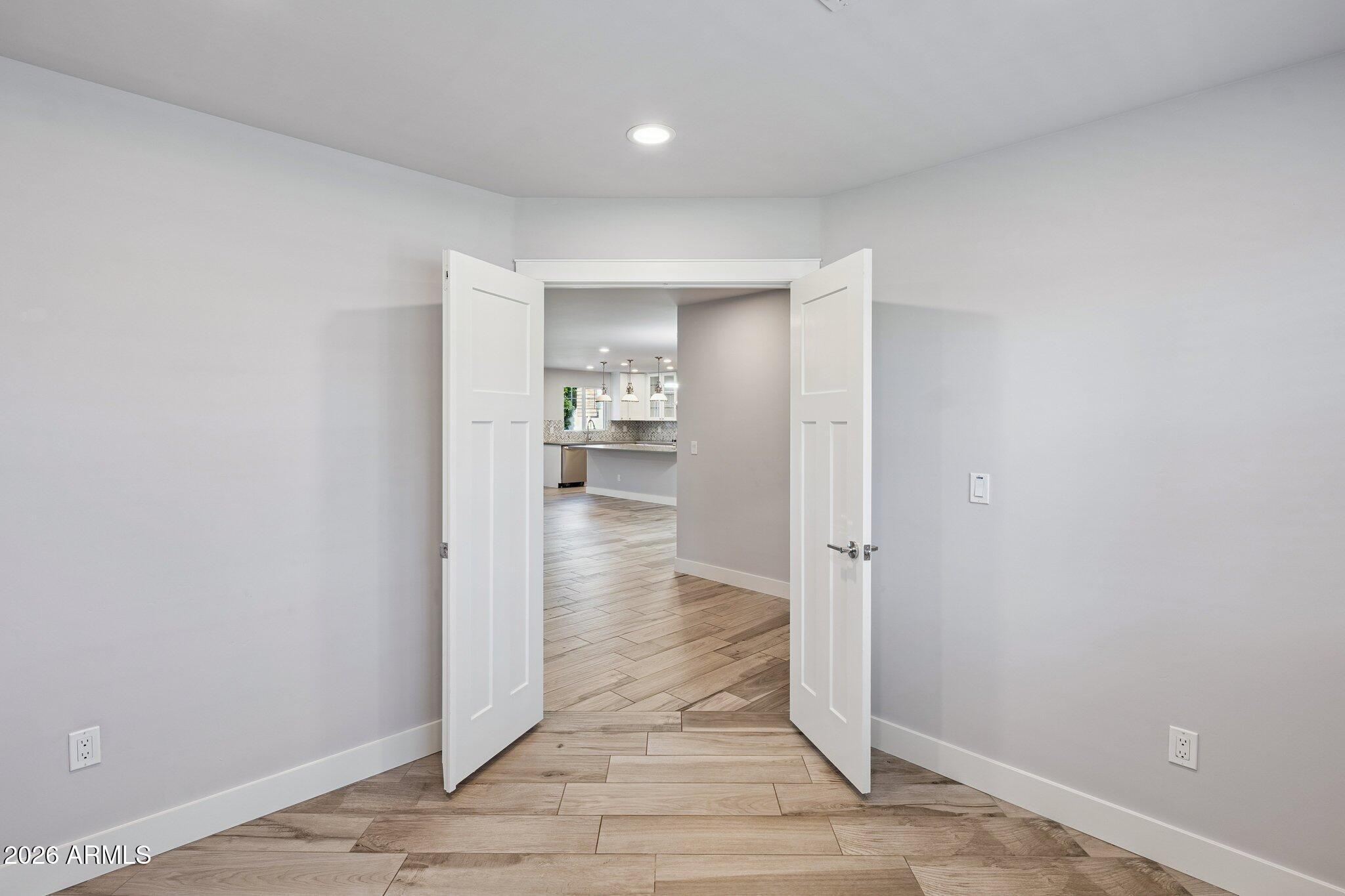4232 North 19th Place Phoenix, AZ 85016 - Photo 31 of 39 a view of a hallway with wooden floor and a bathroom