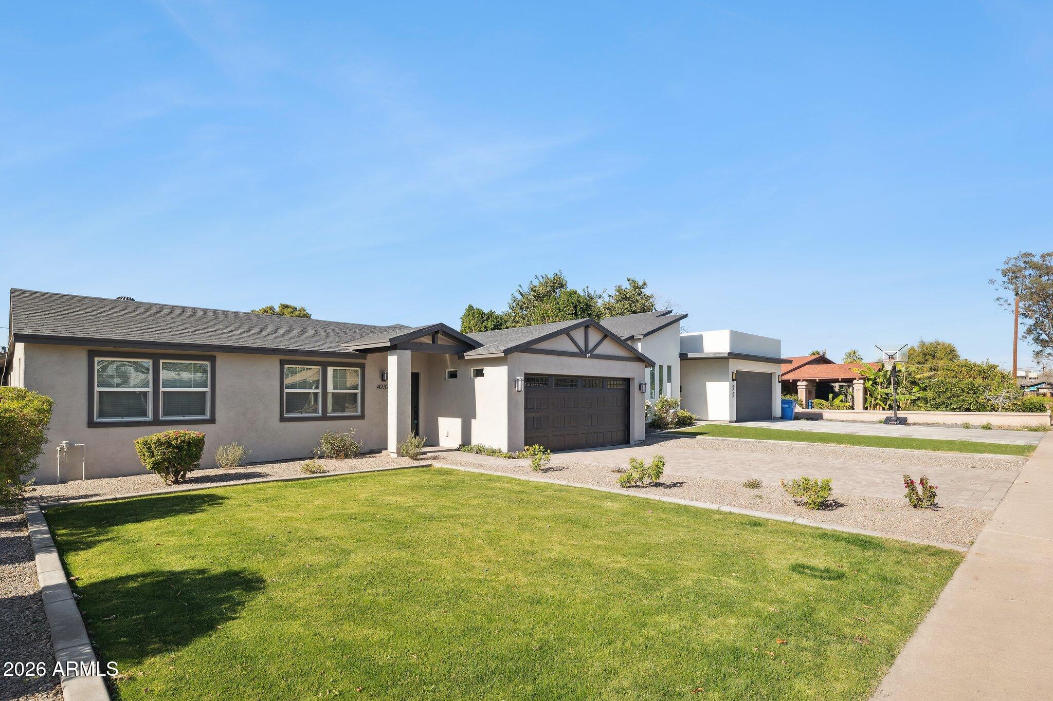 4232 North 19th Place Phoenix, AZ 85016 - Photo 4 of 39 a front view of a house with a yard table and chairs