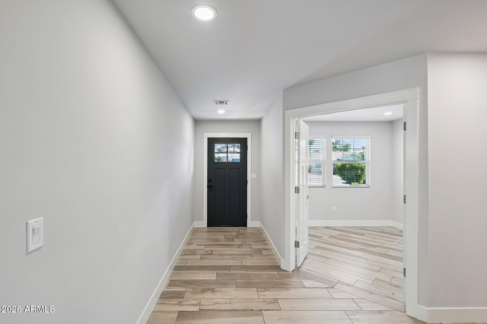 4232 North 19th Place Phoenix, AZ 85016 - Photo 5 of 39 a view of a hallway with wooden floor and a living room