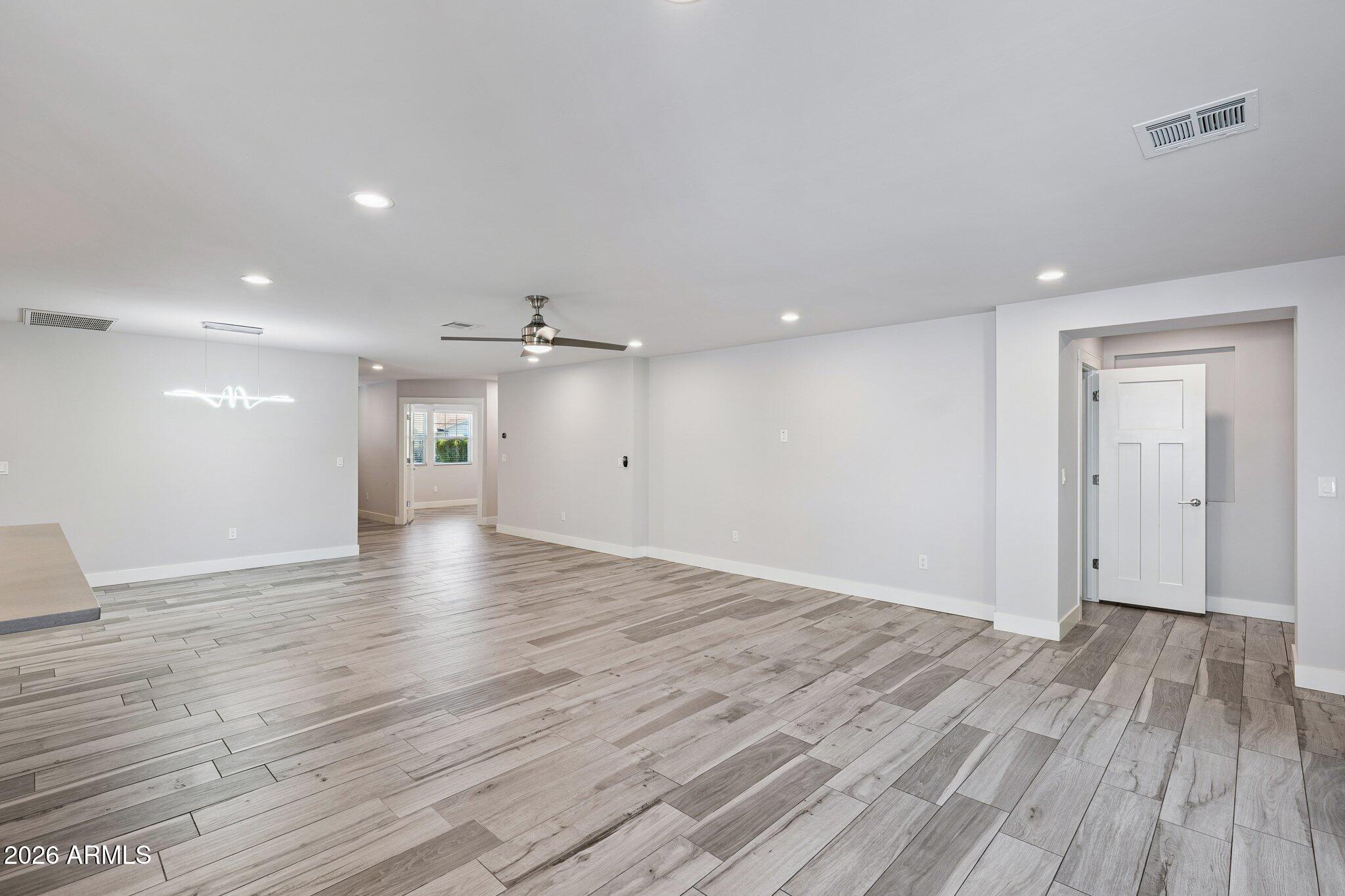 4232 North 19th Place Phoenix, AZ 85016 - Photo 8 of 39 a view of an empty room with wooden floor and a window