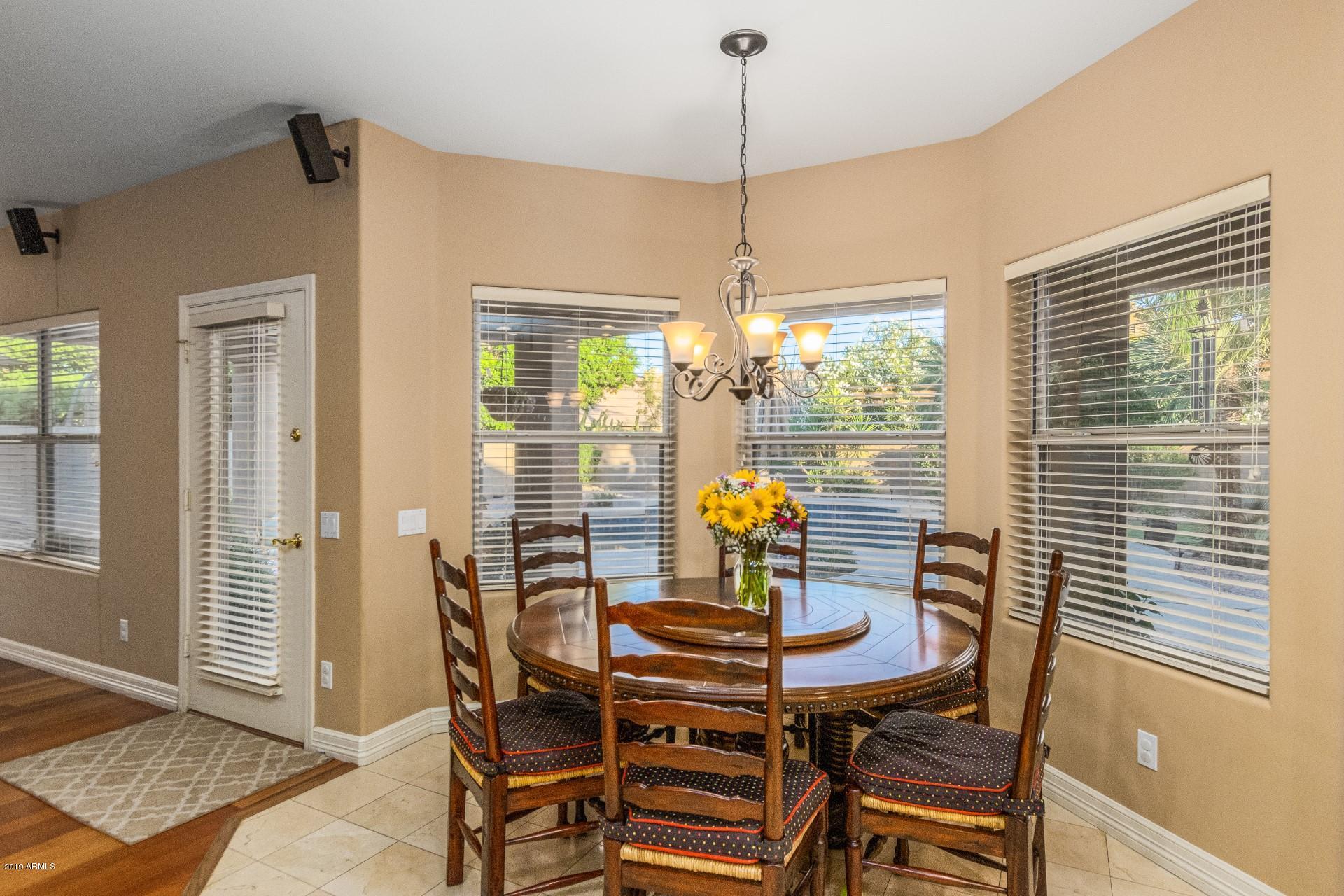 6015 East Phelps Road Scottsdale, AZ 85254 - Photo 17 of 72 a view of a dining room with furniture and window