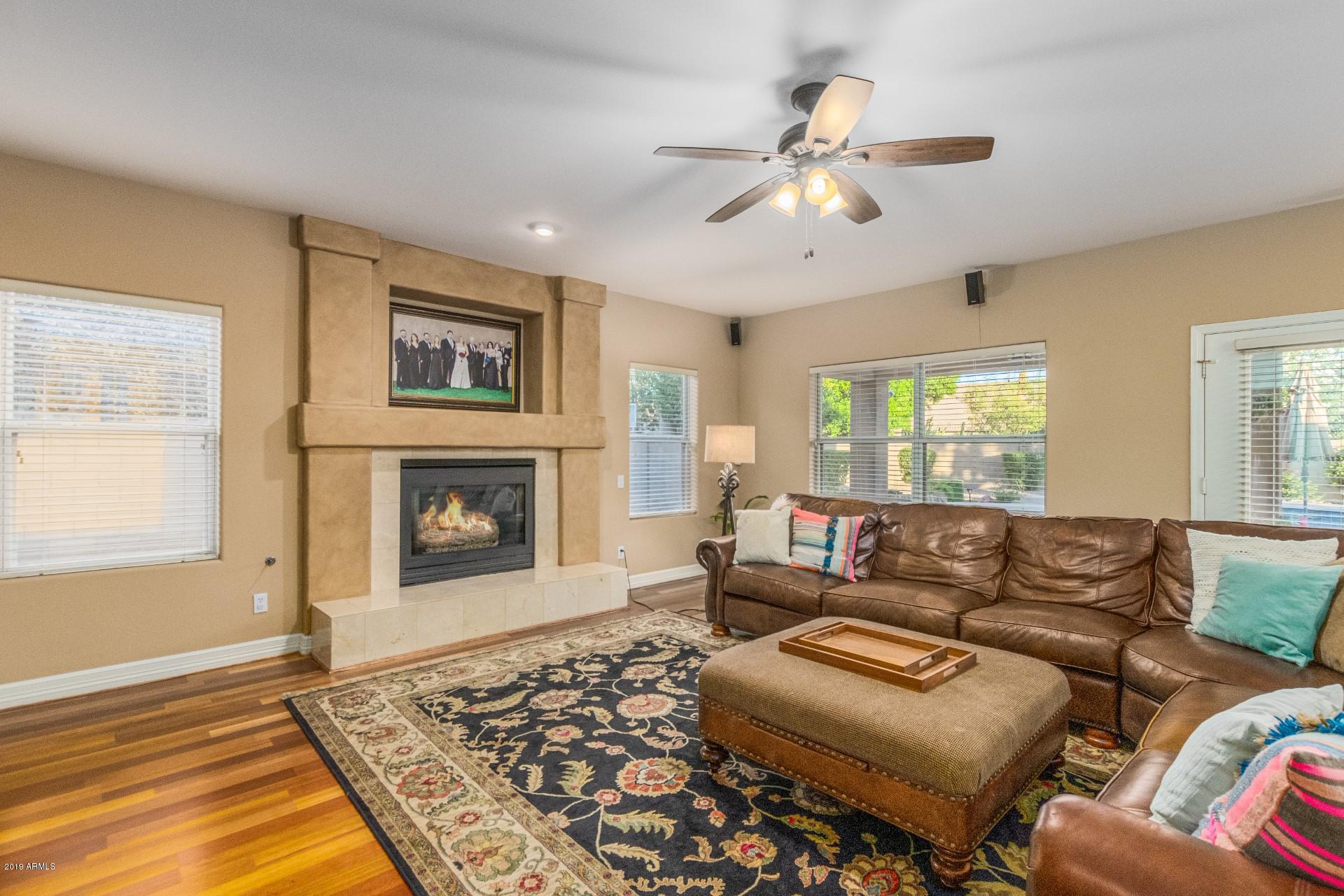 6015 East Phelps Road Scottsdale, AZ 85254 - Photo 18 of 72 a living room with furniture and a fireplace
