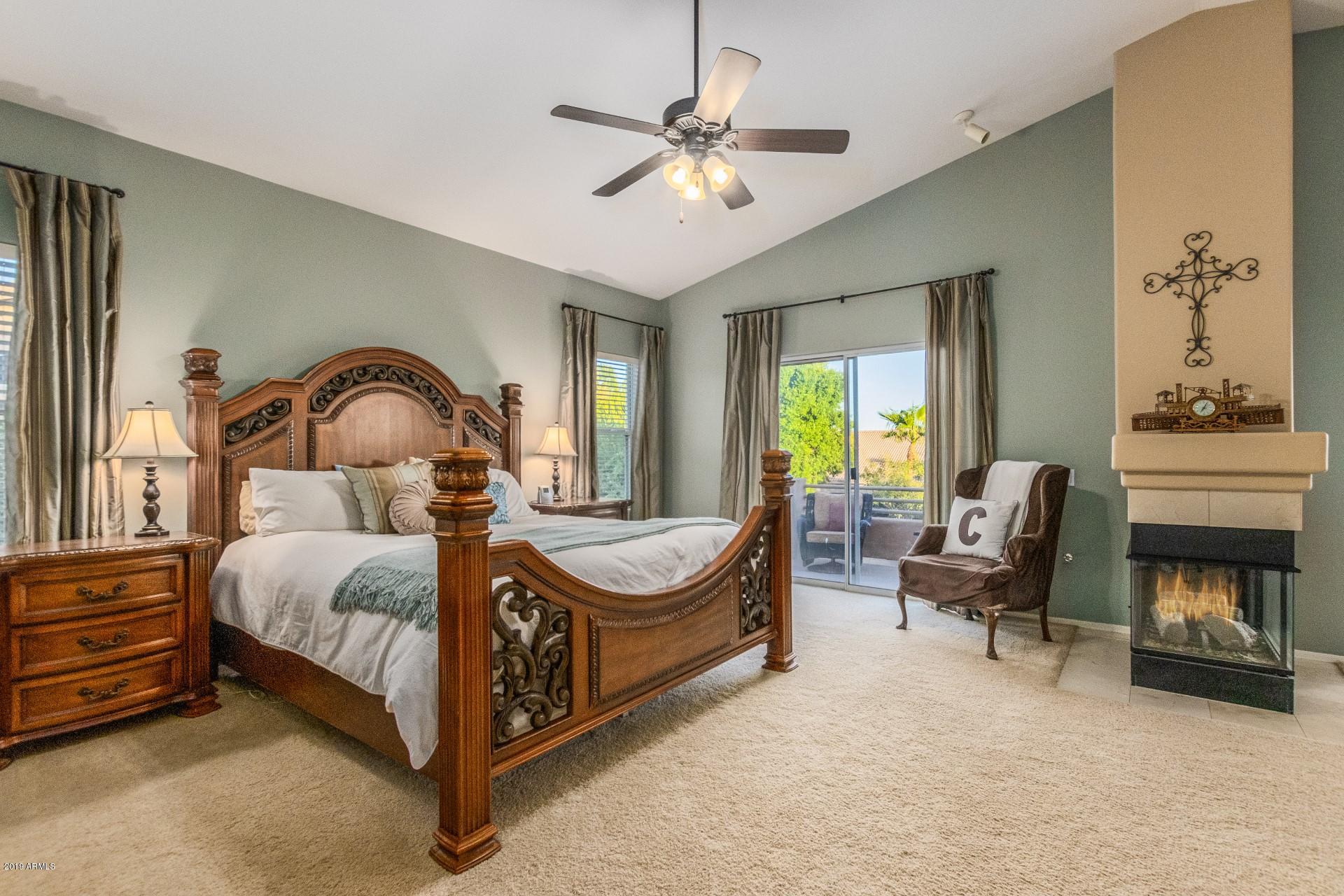 6015 East Phelps Road Scottsdale, AZ 85254 - Photo 25 of 72 a bedroom with a bed chair and fireplace