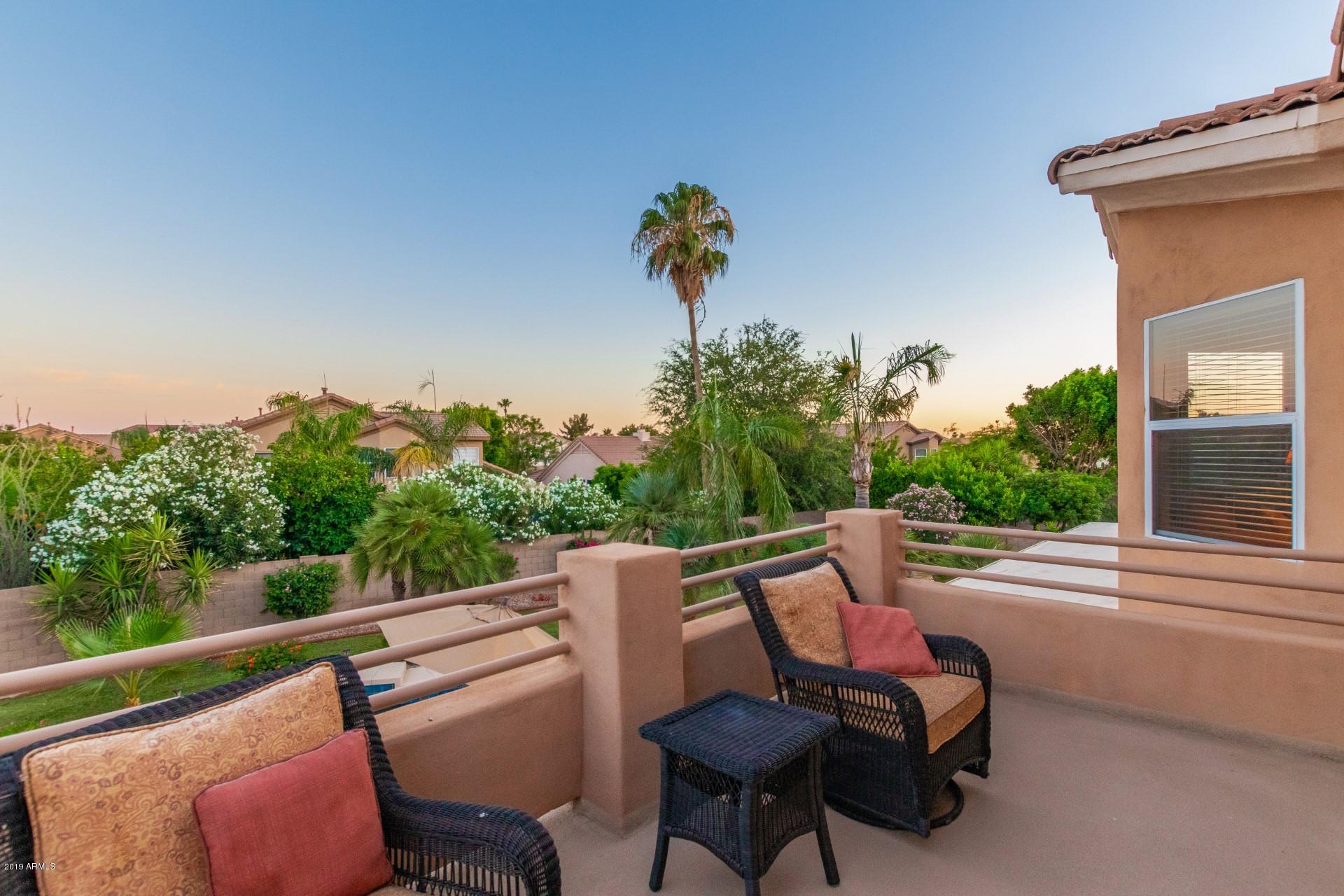 6015 East Phelps Road Scottsdale, AZ 85254 - Photo 29 of 72 a view of a chair and tables in the balcony