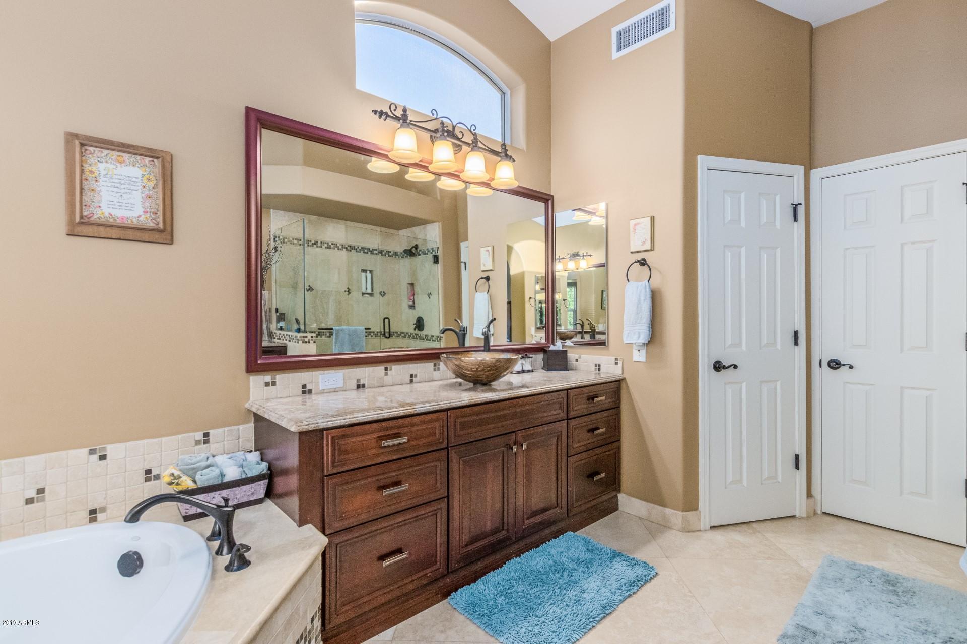 6015 East Phelps Road Scottsdale, AZ 85254 - Photo 32 of 72 a spacious bathroom with a double vanity sink mirror and