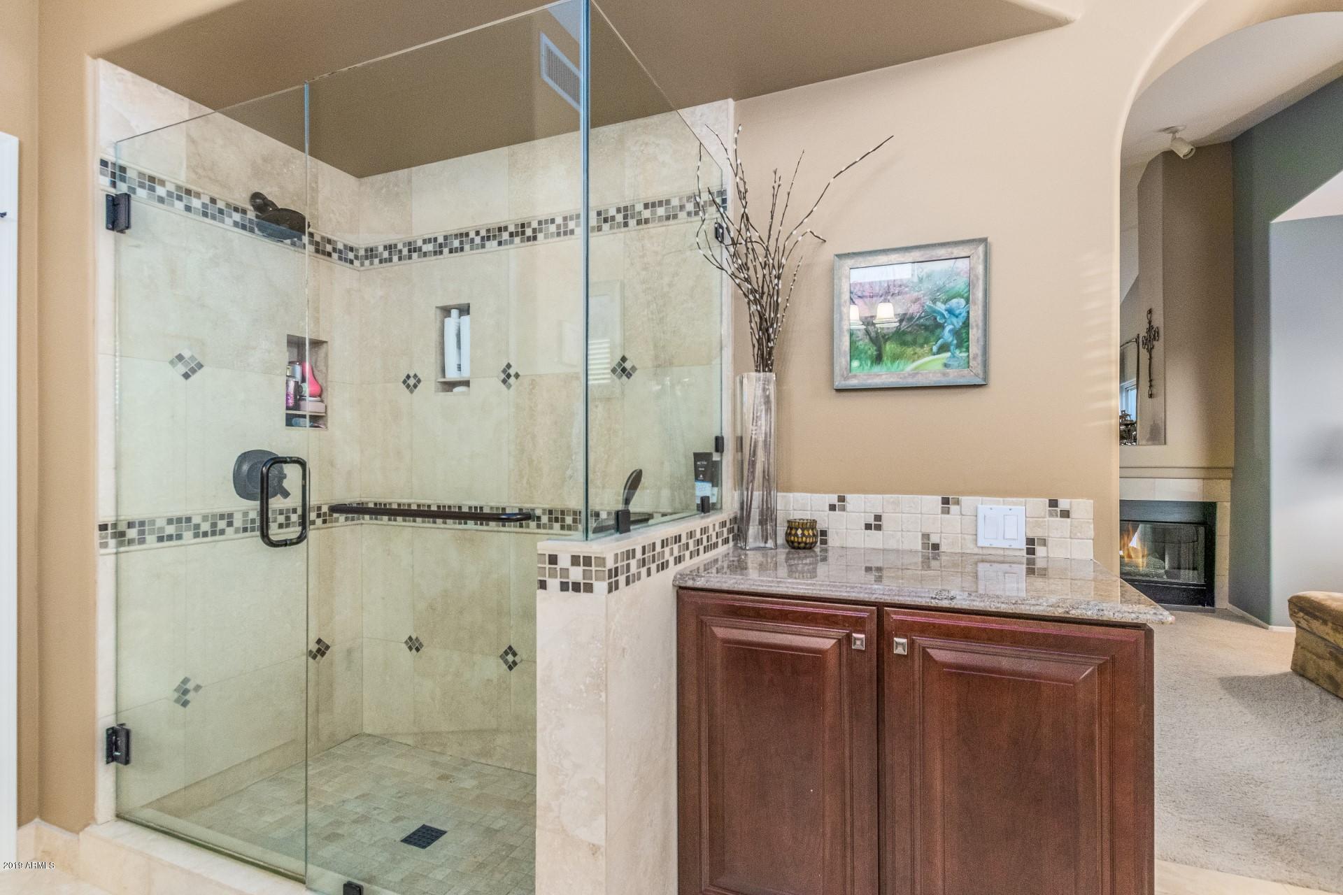 6015 East Phelps Road Scottsdale, AZ 85254 - Photo 33 of 72 a bathroom with a granite countertop shower sink vanity and mirror