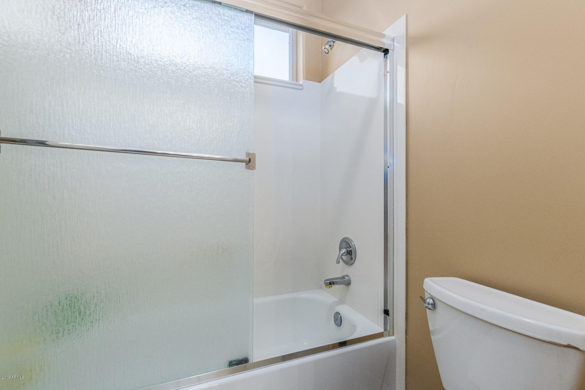 6015 East Phelps Road Scottsdale, AZ 85254 - Photo 36 of 72 a bathroom with a bathtub and a toilet