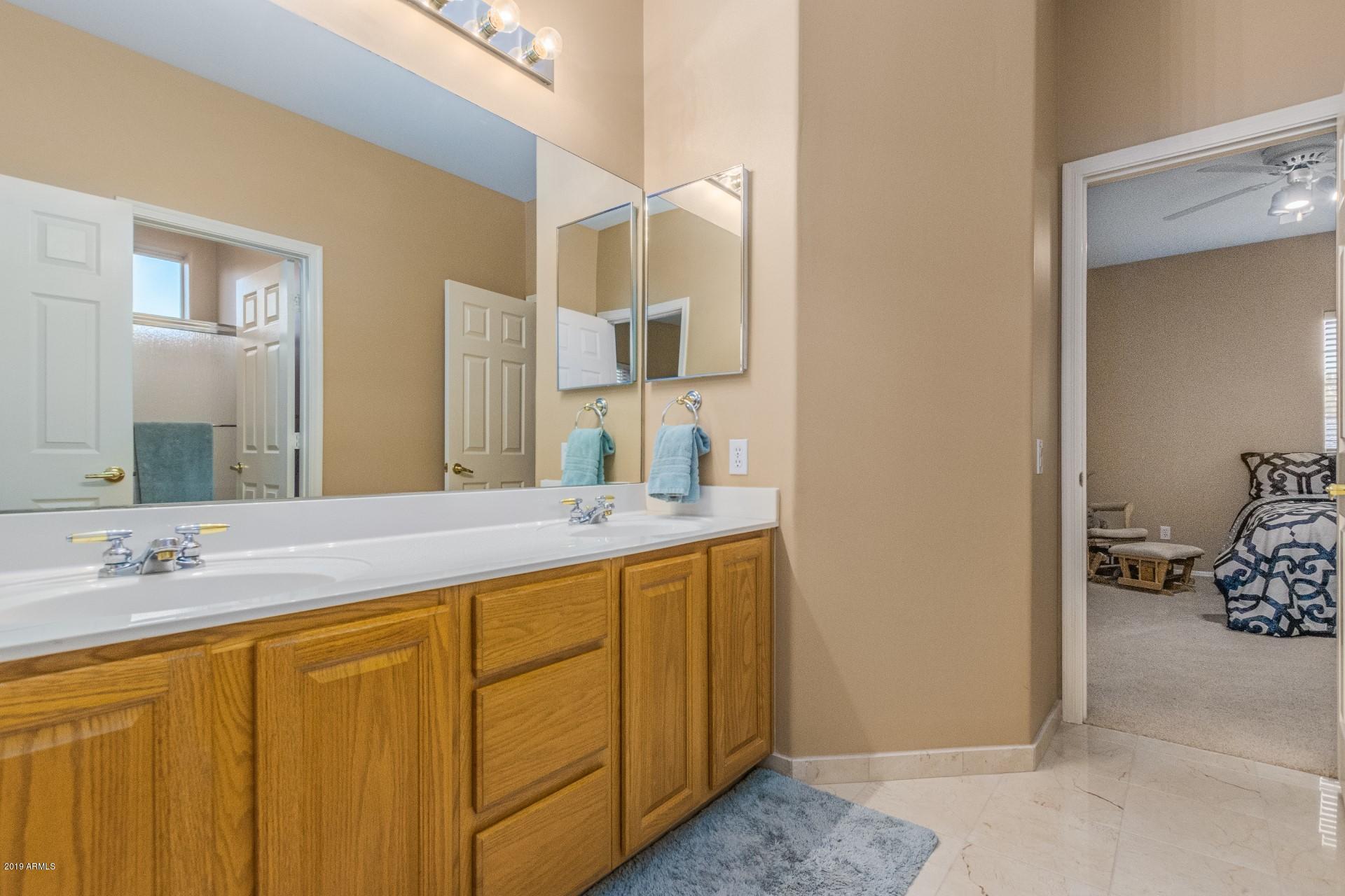 6015 East Phelps Road Scottsdale, AZ 85254 - Photo 37 of 72 a bathroom with a sink and a mirror