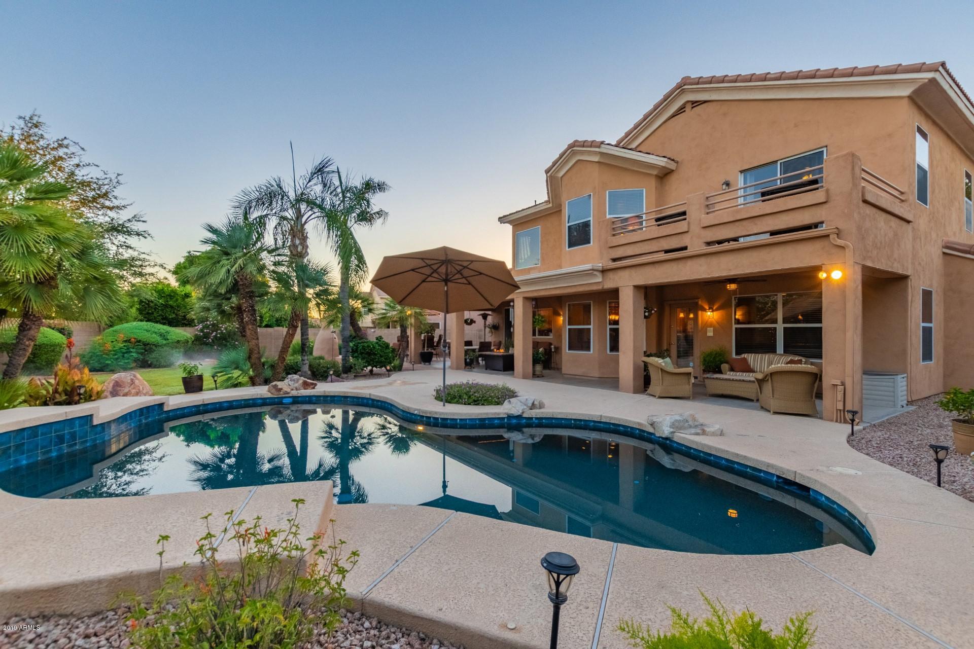 6015 East Phelps Road Scottsdale, AZ 85254 - Photo 4 of 72 a view of a house with pool and chairs