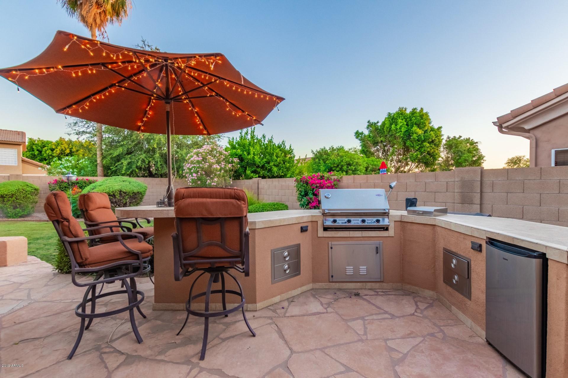 6015 East Phelps Road Scottsdale, AZ 85254 - Photo 48 of 72 a patio with a patio table and chairs