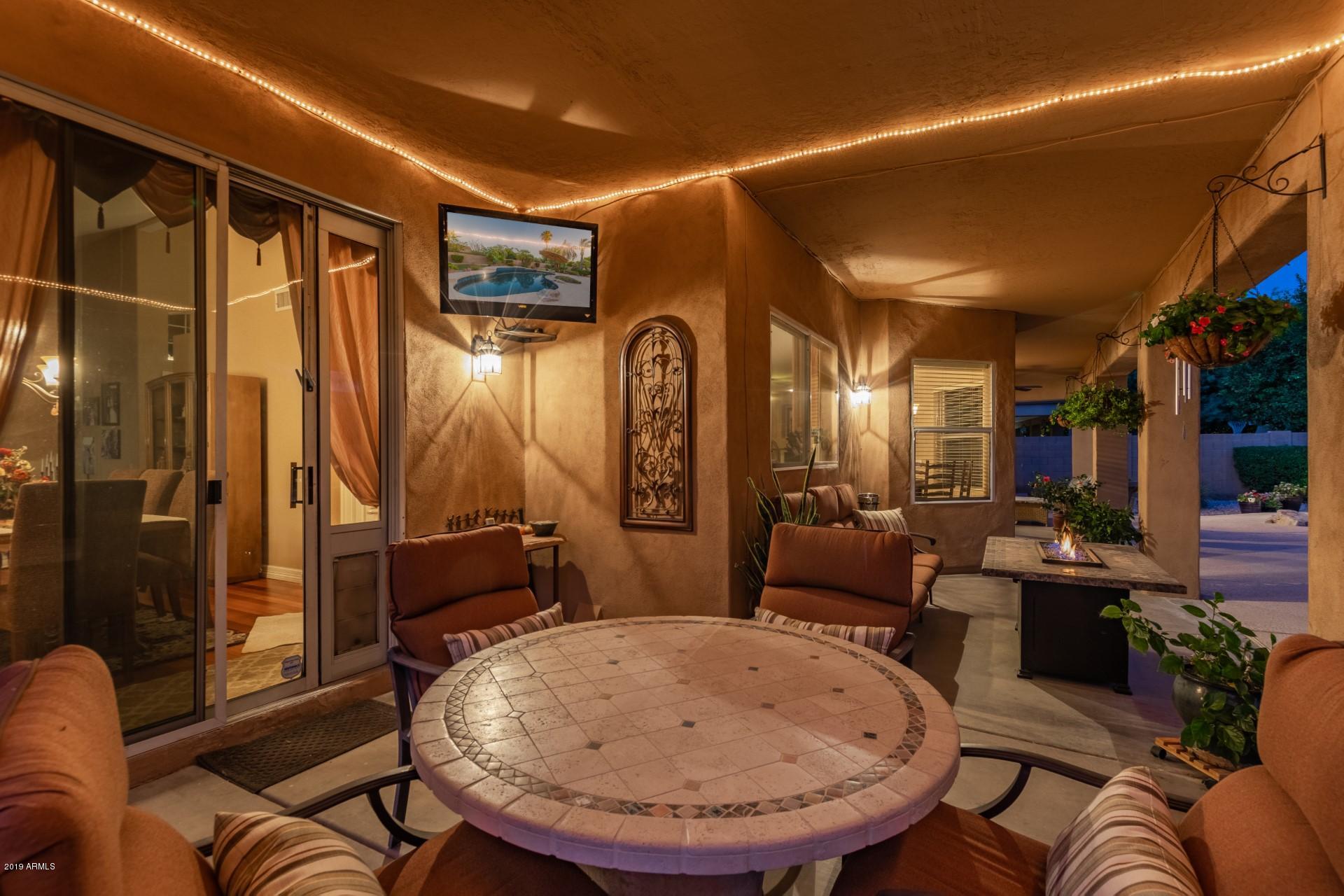 6015 East Phelps Road Scottsdale, AZ 85254 - Photo 59 of 72 a living room with furniture and a mirror