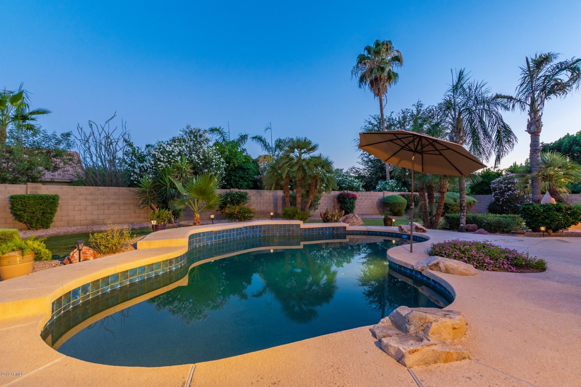 6015 East Phelps Road Scottsdale, AZ 85254 - Photo 61 of 72 a view of a swimming pool with a patio