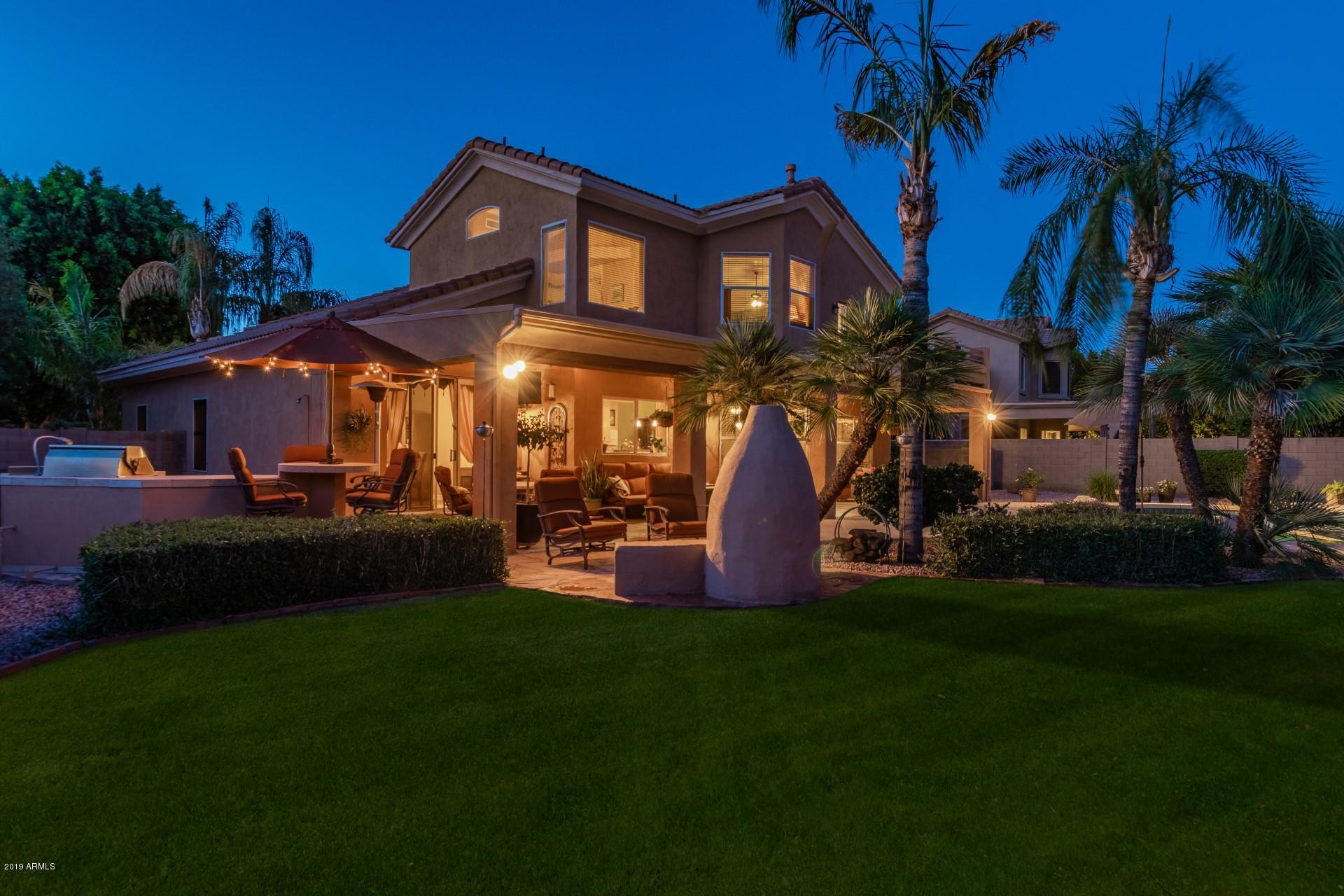6015 East Phelps Road Scottsdale, AZ 85254 - Photo 68 of 72 a front view of a house with garden and sitting area
