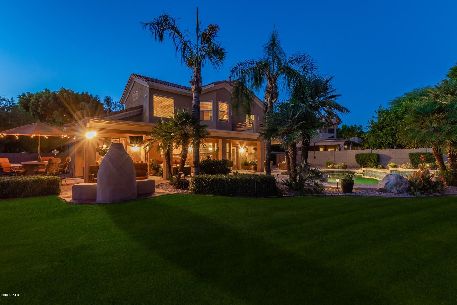 6015 East Phelps Road Scottsdale, AZ 85254 - Photo 69 of 72 a front view of a house with a garden and yard