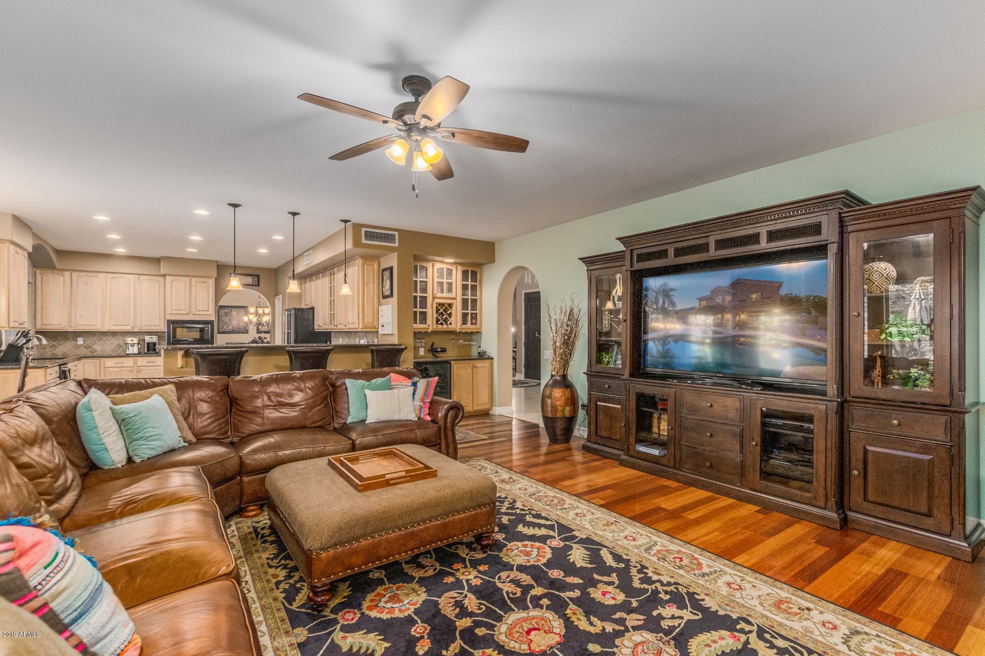 6015 East Phelps Road Scottsdale, AZ 85254 - Photo 7 of 72 a living room with furniture and a flat screen tv