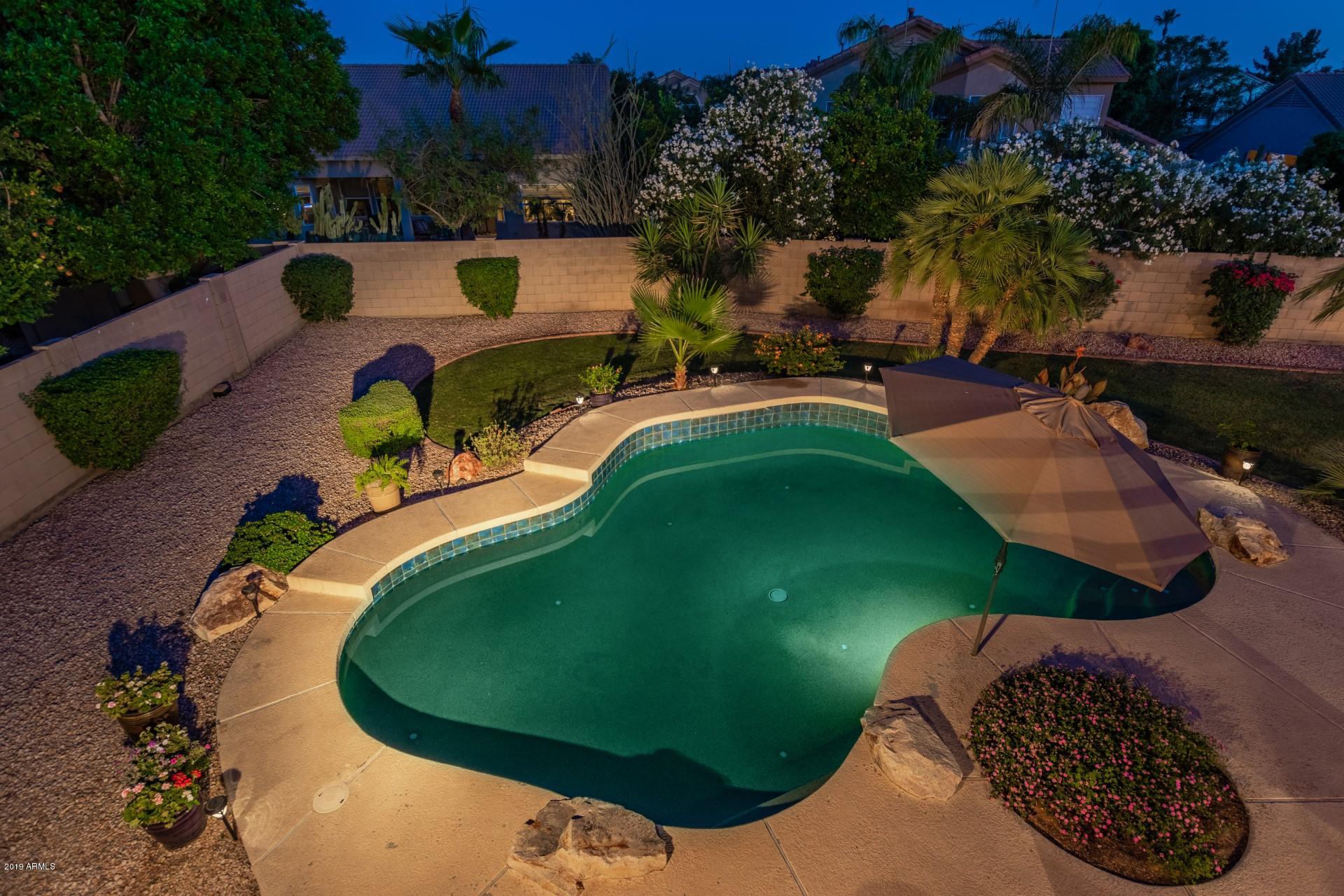 6015 East Phelps Road Scottsdale, AZ 85254 - Photo 71 of 72 a view of a swimming pool in a backyard