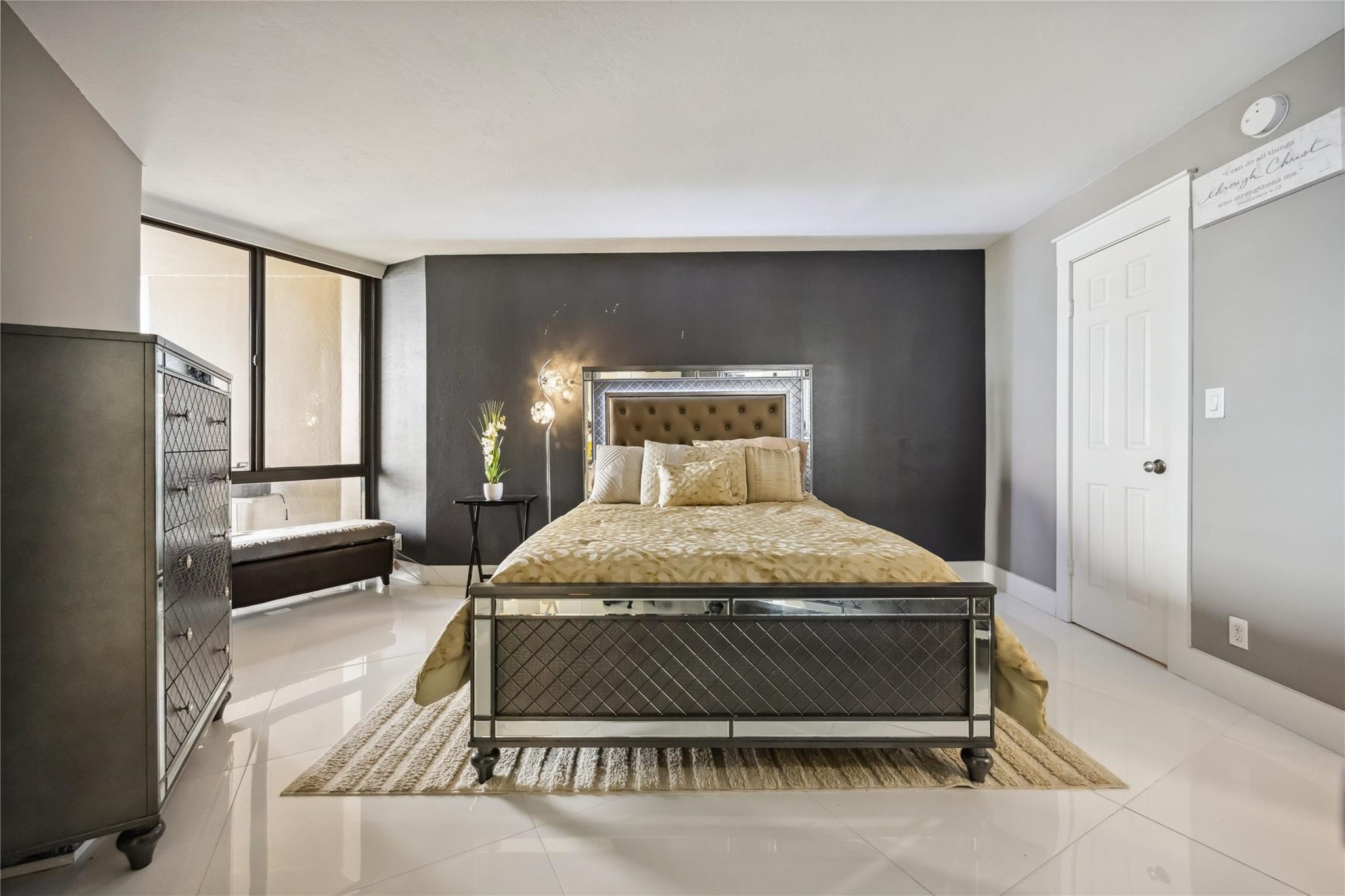 3525 Sage Road, Unit 1713 Houston, TX 77056 - Photo 10 of 25 Spacious primary suite with sleek porcelain floors, dramatic accent wall, and room for a sitting area—your private retreat in the sky.