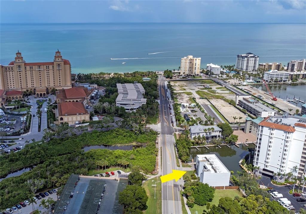 377 Vanderbilt Beach Road, Unit 201 Naples, FL 34108 - Photo 1 of 1 a view of a city with tall buildings