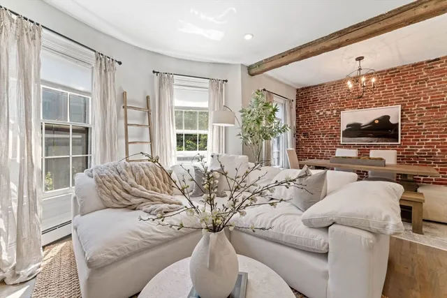 a living room with furniture a large window and a flat screen tv