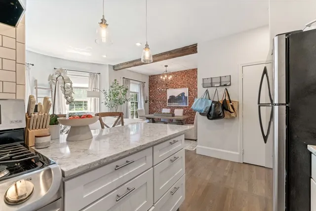 a kitchen with stainless steel appliances granite countertop a sink a stove and a refrigerator