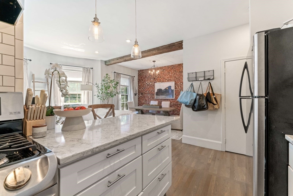 91 Waltham Street, Unit 4 Boston, MA 02118 - Photo 14 of 26 a kitchen with stainless steel appliances granite countertop a sink a stove and a refrigerator
