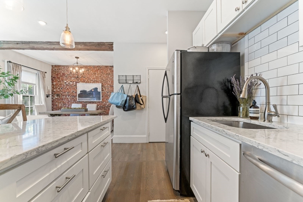 91 Waltham Street, Unit 4 Boston, MA 02118 - Photo 15 of 26 a kitchen with stainless steel appliances a sink stove and refrigerator