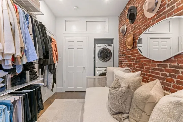a view of walk in closet with clothes and shoes