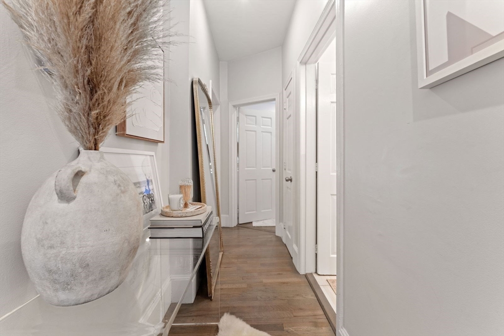 91 Waltham Street, Unit 4 Boston, MA 02118 - Photo 22 of 26 a view of a hallway with wooden floor and entryway