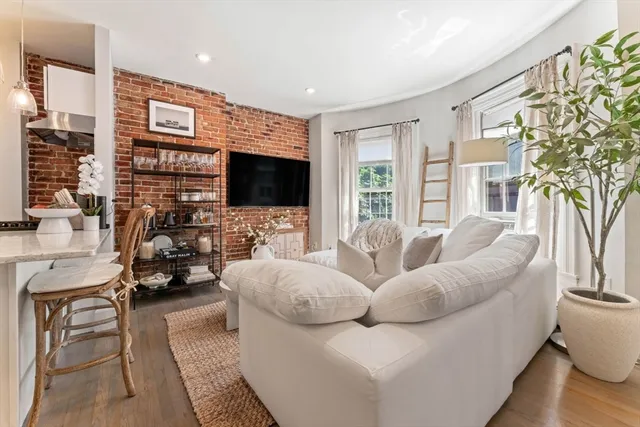 a living room with furniture fireplace and a flat screen tv