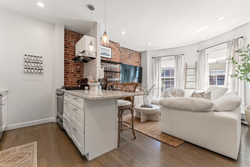 91 Waltham Street, Unit 4 Boston, MA 02118 - Photo 8 of 26 a living room with furniture and a large window