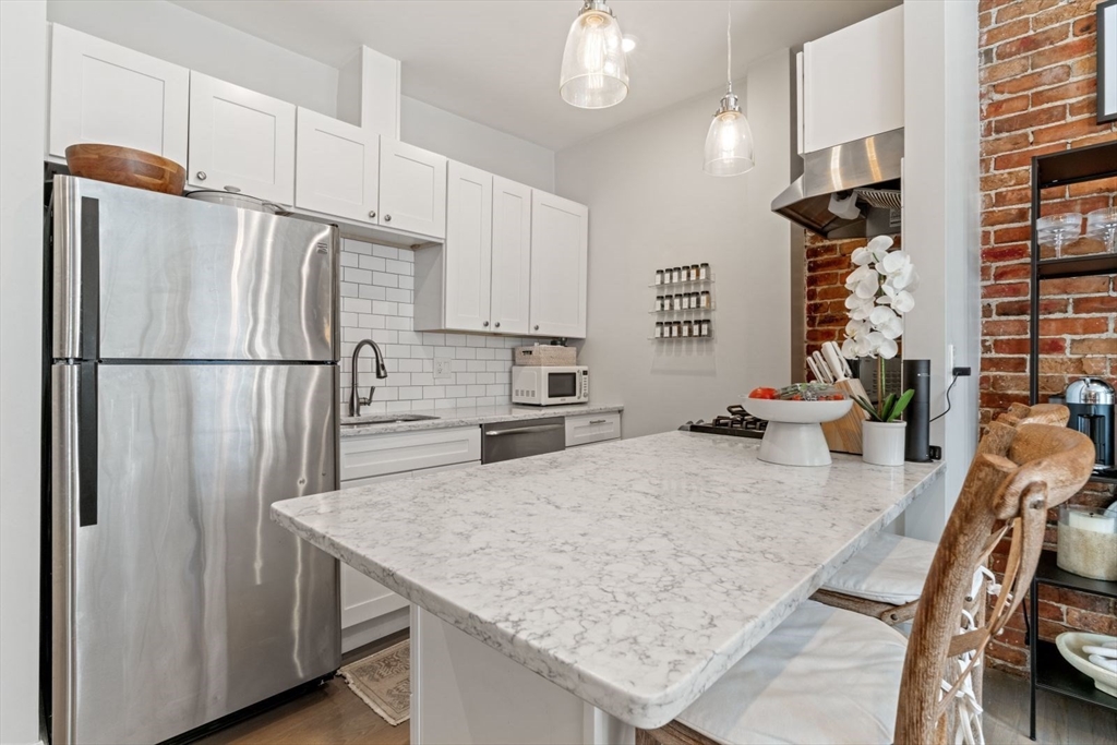 91 Waltham Street, Unit 4 Boston, MA 02118 - Photo 10 of 26 a kitchen with refrigerator and countertop