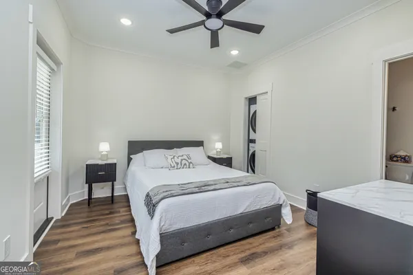 a bedroom with a bed and a chandelier
