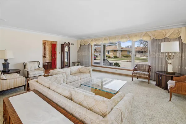 a living room with furniture and a floor to ceiling window