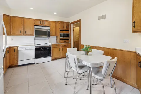 a kitchen with stainless steel appliances a stove a sink a microwave and a refrigerator