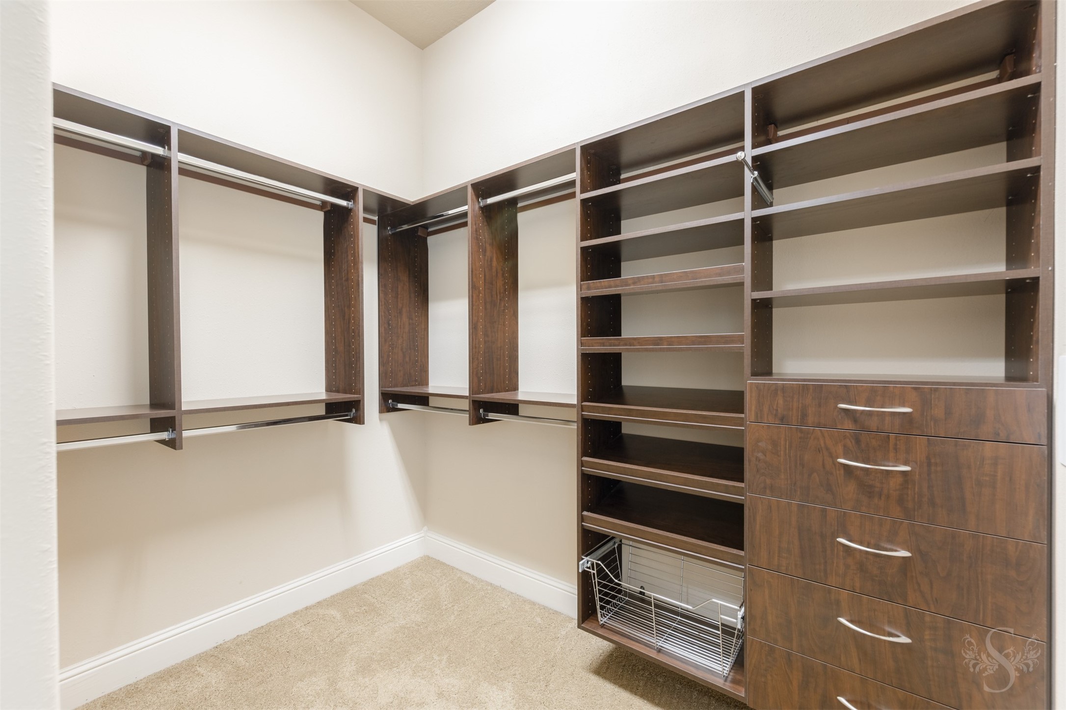 5803 Mustang Ridge Lane Fulshear, TX 77441 - Photo 19 of 48 Custom primary closet offers abundant built-in storage, multiple hanging areas and dedicated shelving throughout. The spacious layout creates an organized, boutique-style feel with room for every wardrobe essential.
