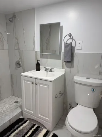 a view of a balcony with chairs and wooden fence