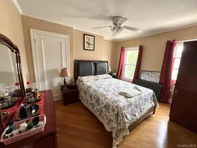 a bed sitting in a bedroom next to a window