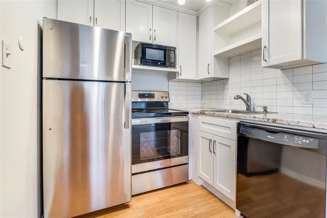 a kitchen with a refrigerator sink and microwave