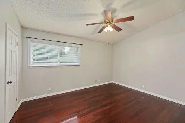 a view of a room with wooden floor and windows