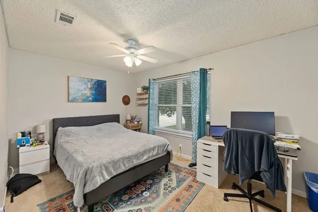 a bedroom with a bed closet and a window