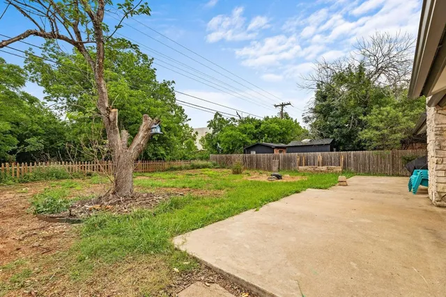 a view of a backyard with large trees