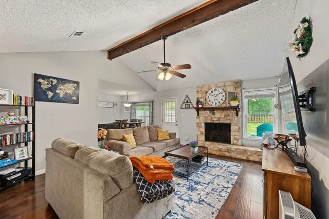 a living room with furniture a fireplace and a flat screen tv
