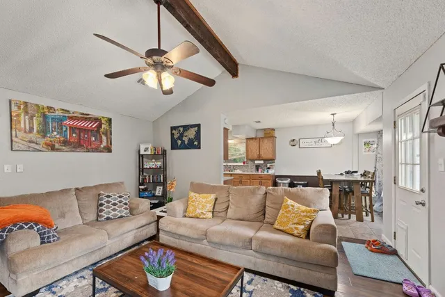 a living room with furniture and a chandelier
