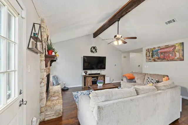 a living room with furniture and a flat screen tv