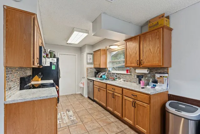a kitchen with stainless steel appliances granite countertop a sink stove and cabinets
