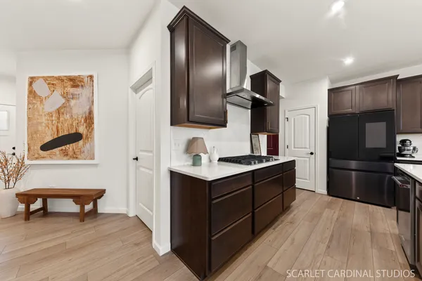 a large kitchen with a stove and a refrigerator