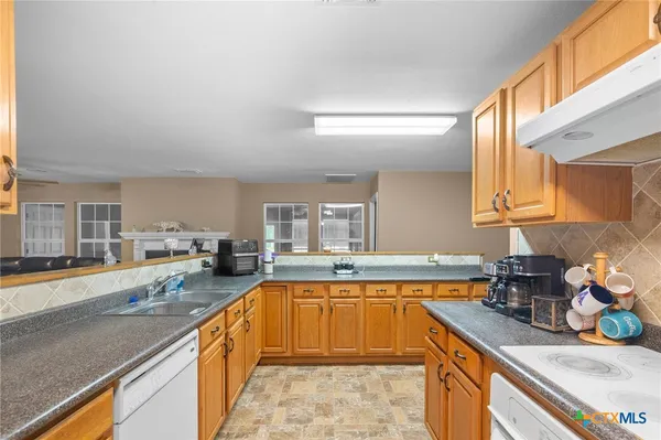 a large kitchen with a sink and cabinets