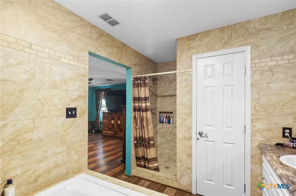 a bathroom with a tub and shower view