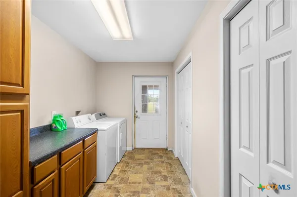 a hallway with cabinets and wooden floor